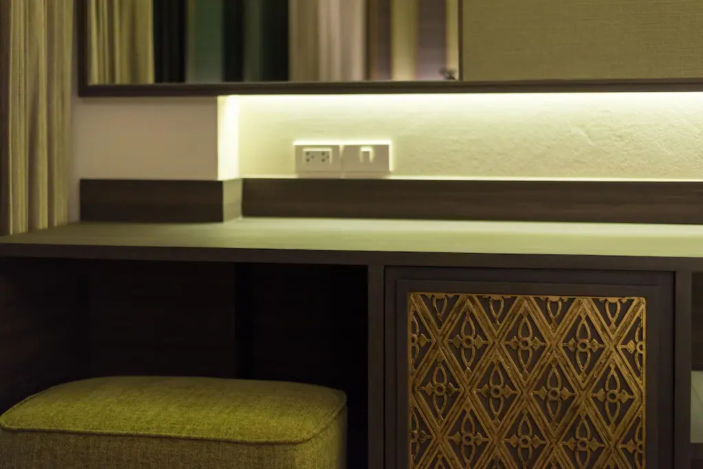 Writing desk and Thai-patterned cabinet in a Deluxe Room