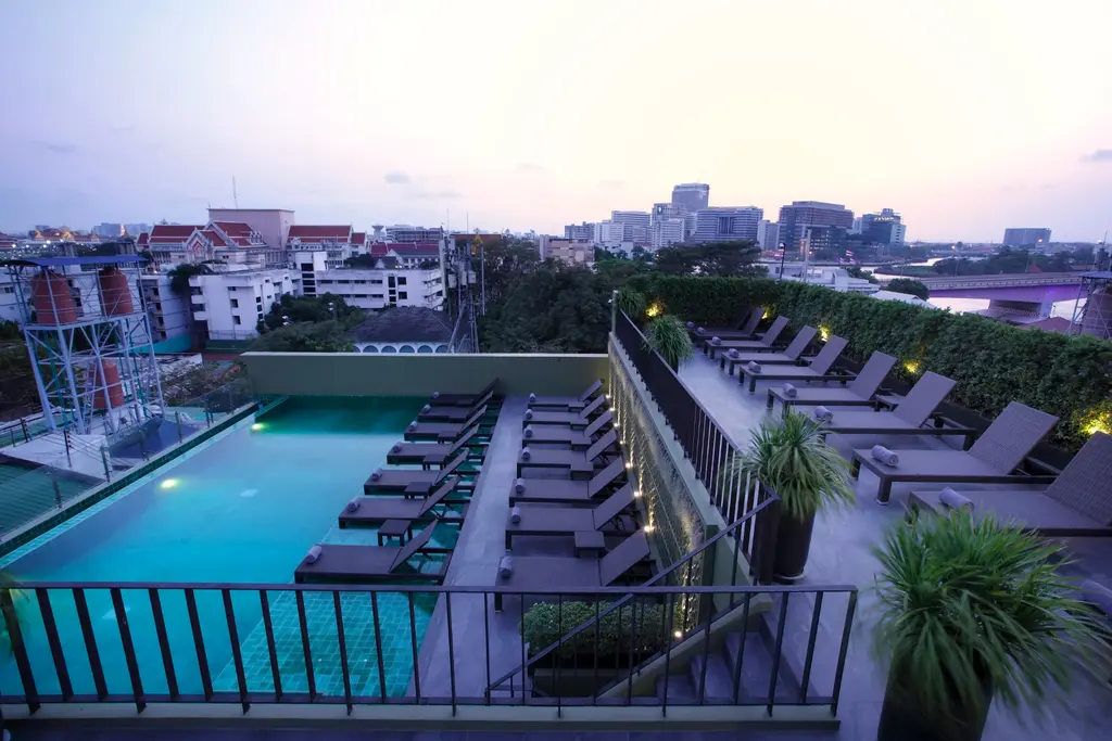 Rooftop swimming pool glowing at dusk